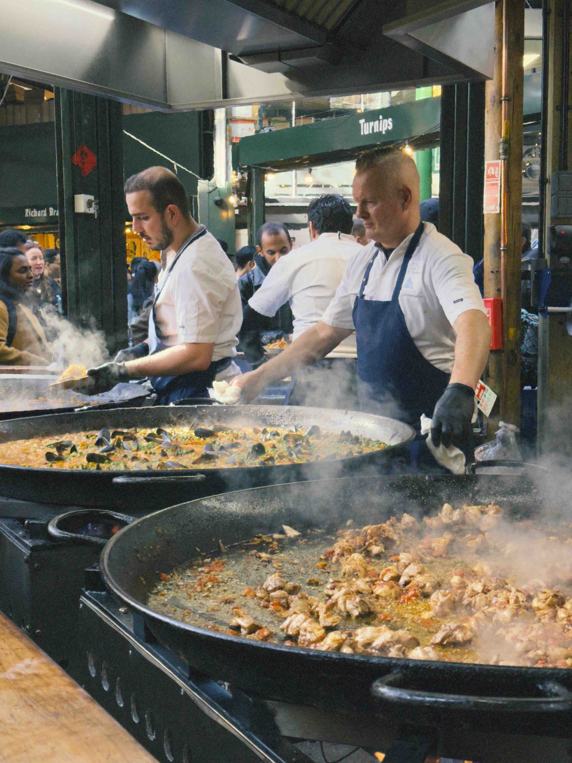 Two men cooking Paella at Borough Market (Budget-Friendly Weekend in London)