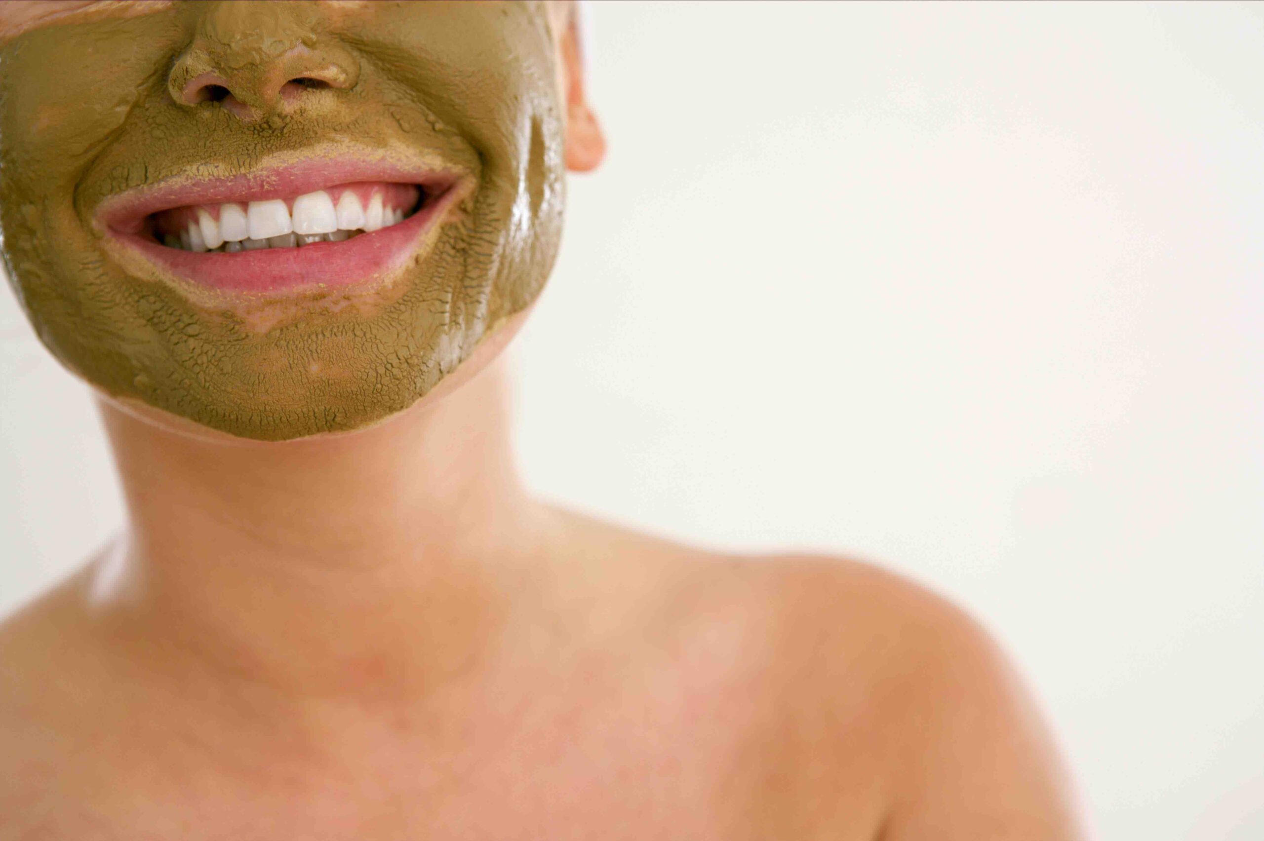 A green mask on a lady who is smiling. (Inexpensive Self-Care Solutions for Women in London)