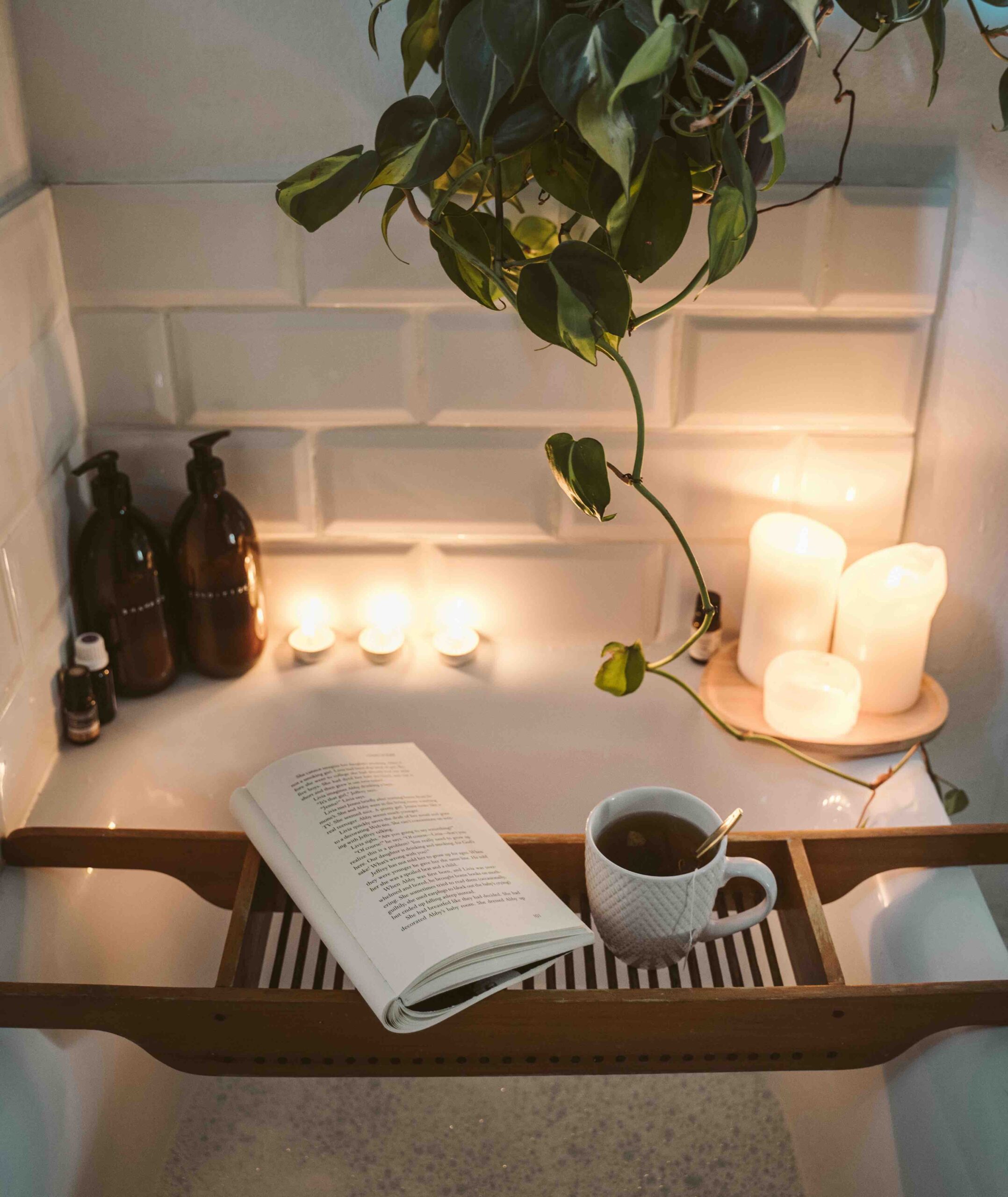 Bubble bath with a wooden table that holds a book and a cup of tea. (Affordable Health and Wellness for Women in London)